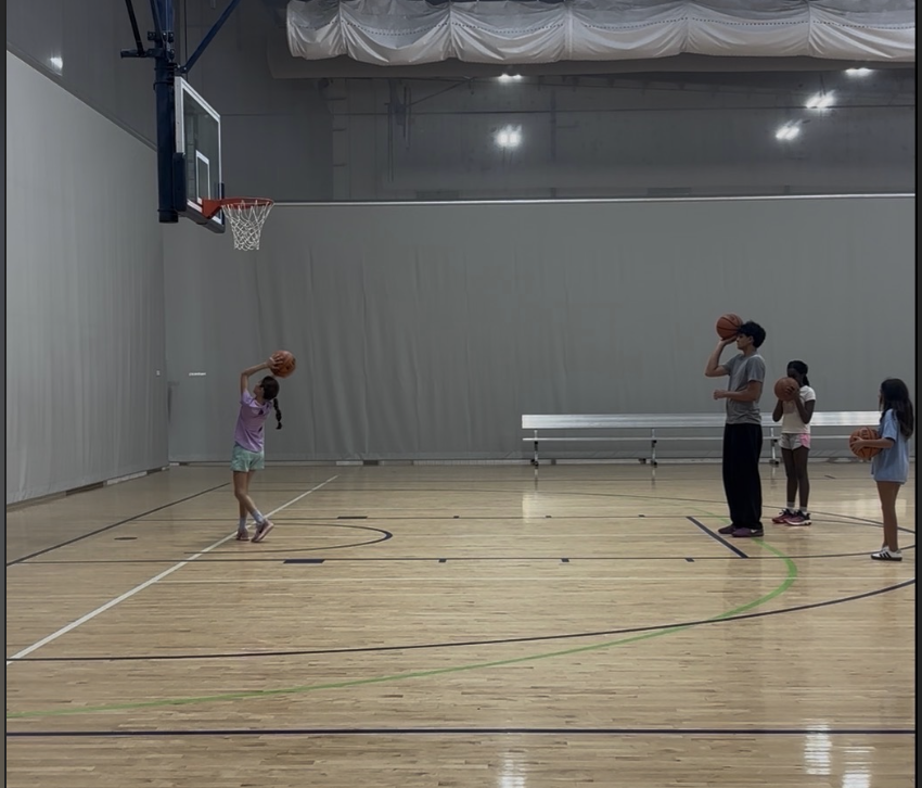 Kids practicing dribbling drills with a coach